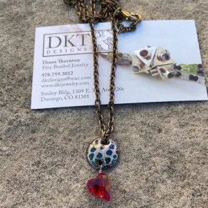 Enamel pendant necklace with a crystal heart