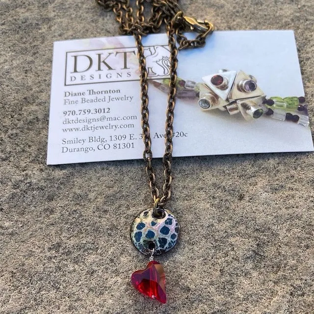Enamel pendant necklace with a crystal heart